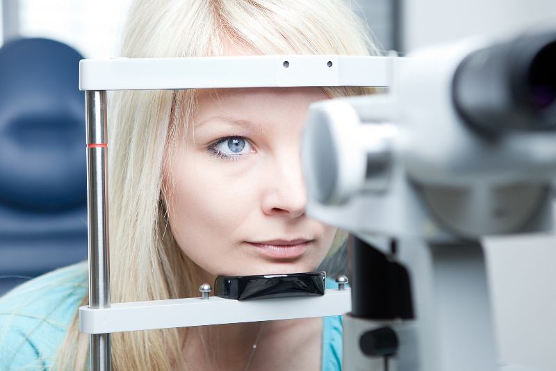 young woman having her eyes examined